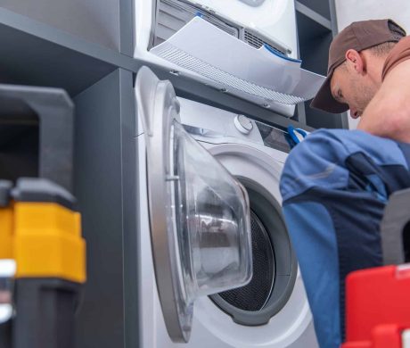 Technician Repairs Broken Washing Machine